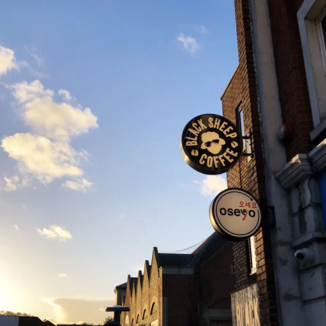 black sheep coffee house circular projecting sign