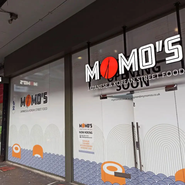 momos japanese and korean street food illuminated shop front sign for restaurant