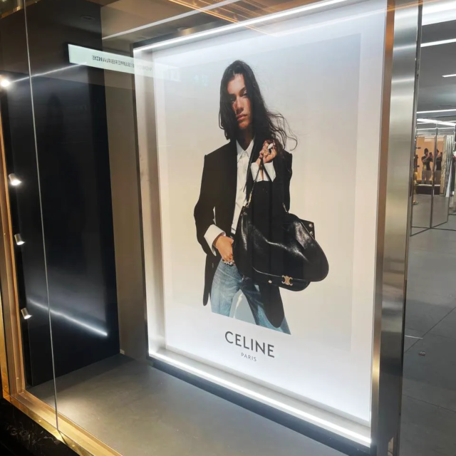 poster for celine featured in shop front window in westfields