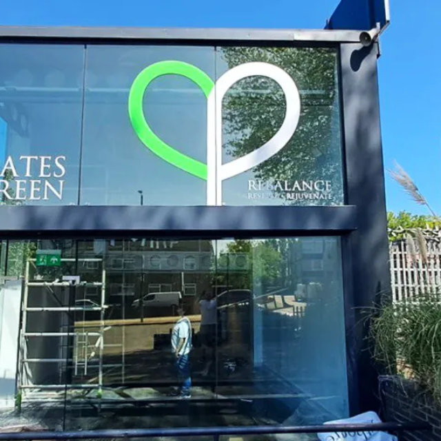 pilates by the green vinyl sign for glass