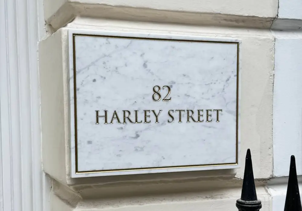 city clinics gold etched door number sign on marble harley street